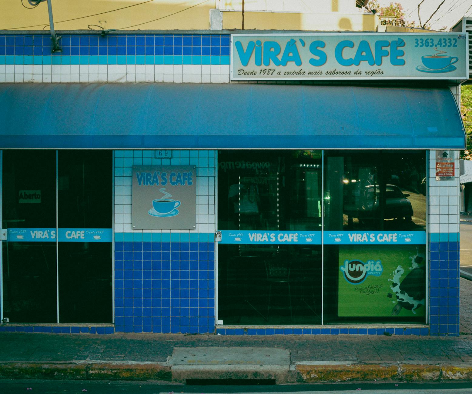 A cozy street view of Vira's Café featuring a distinctive blue tiled facade.