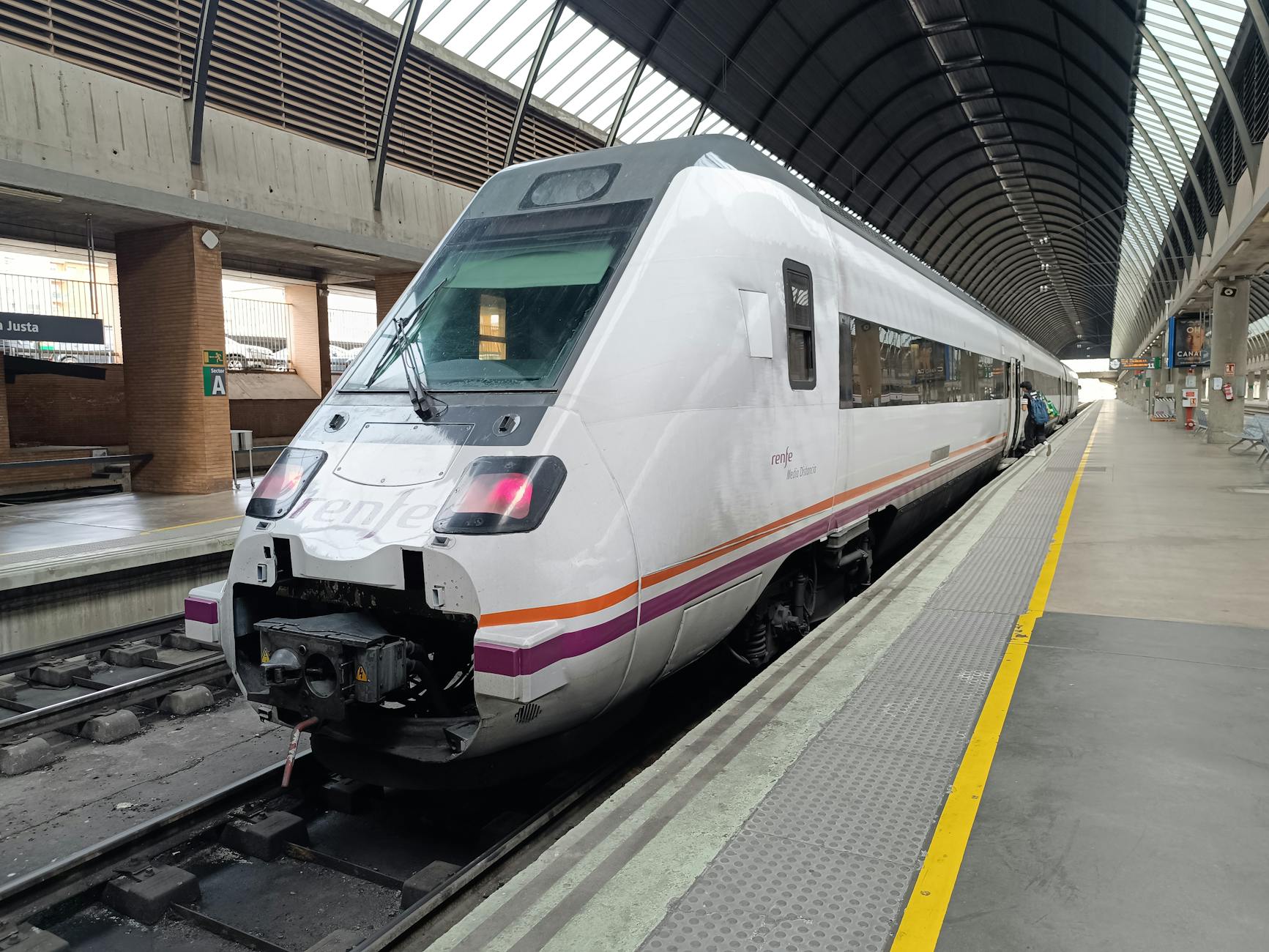A sleek, modern train at Sevilla Santa Justa railway station in Spain.