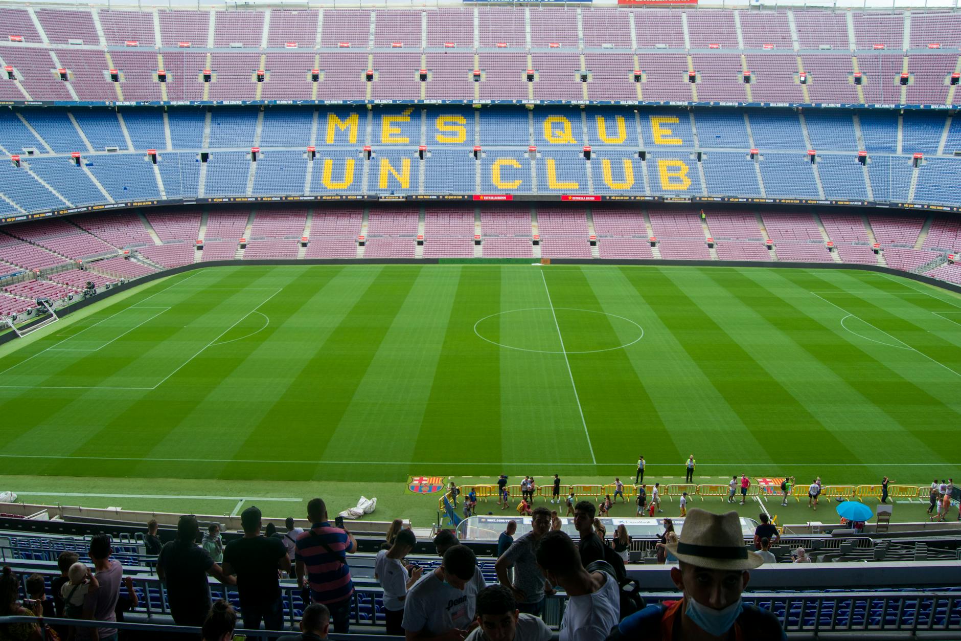 Aerial view of Camp Nou Stadium in Barcelona, showcasing the iconic 'Més Que Un Club' seating in daylight.