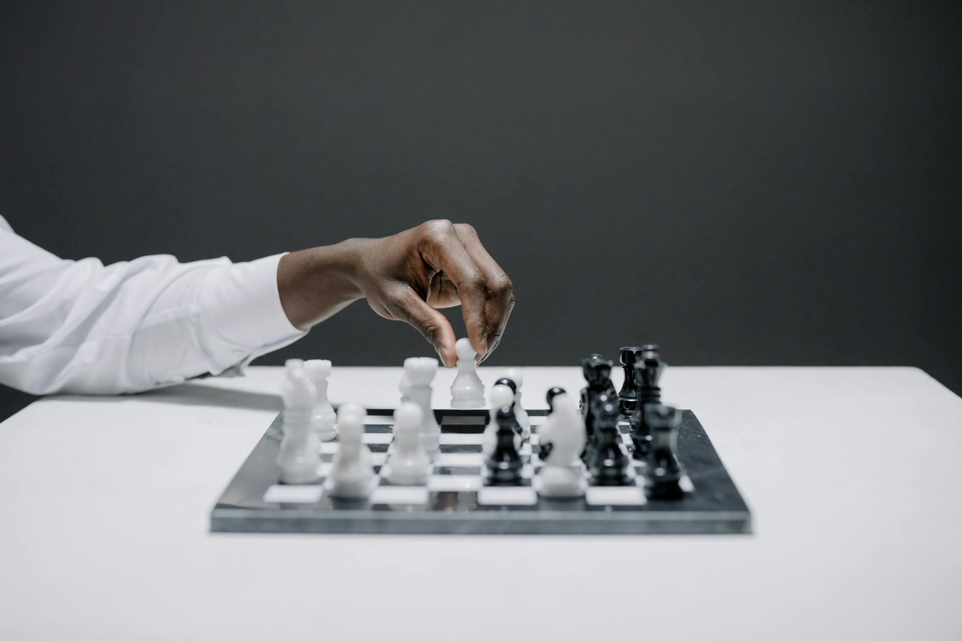 An intense moment of strategic decision-making on a contemporary chessboard.