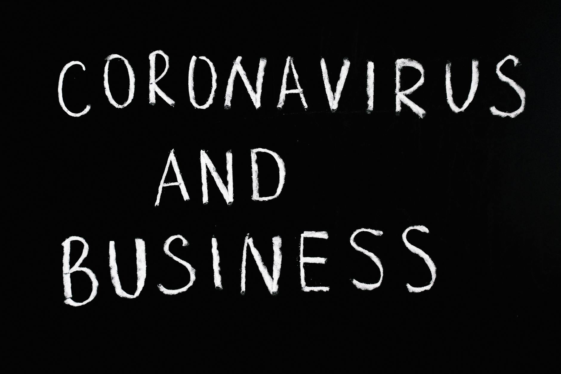 Chalkboard with 'Coronavirus and Business' written on it, illustrating COVID-19 impact.