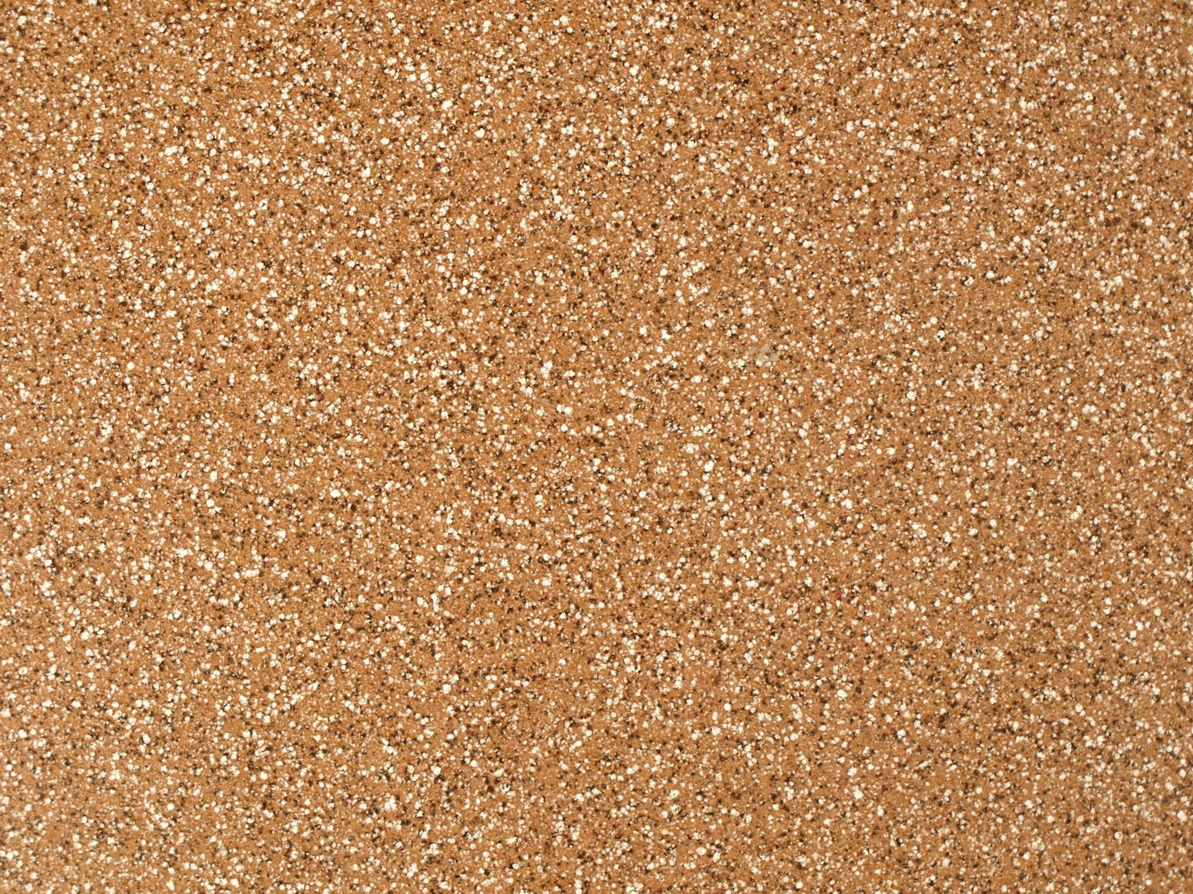 Close-up view of a granular sandstone surface texture, ideal for backgrounds.