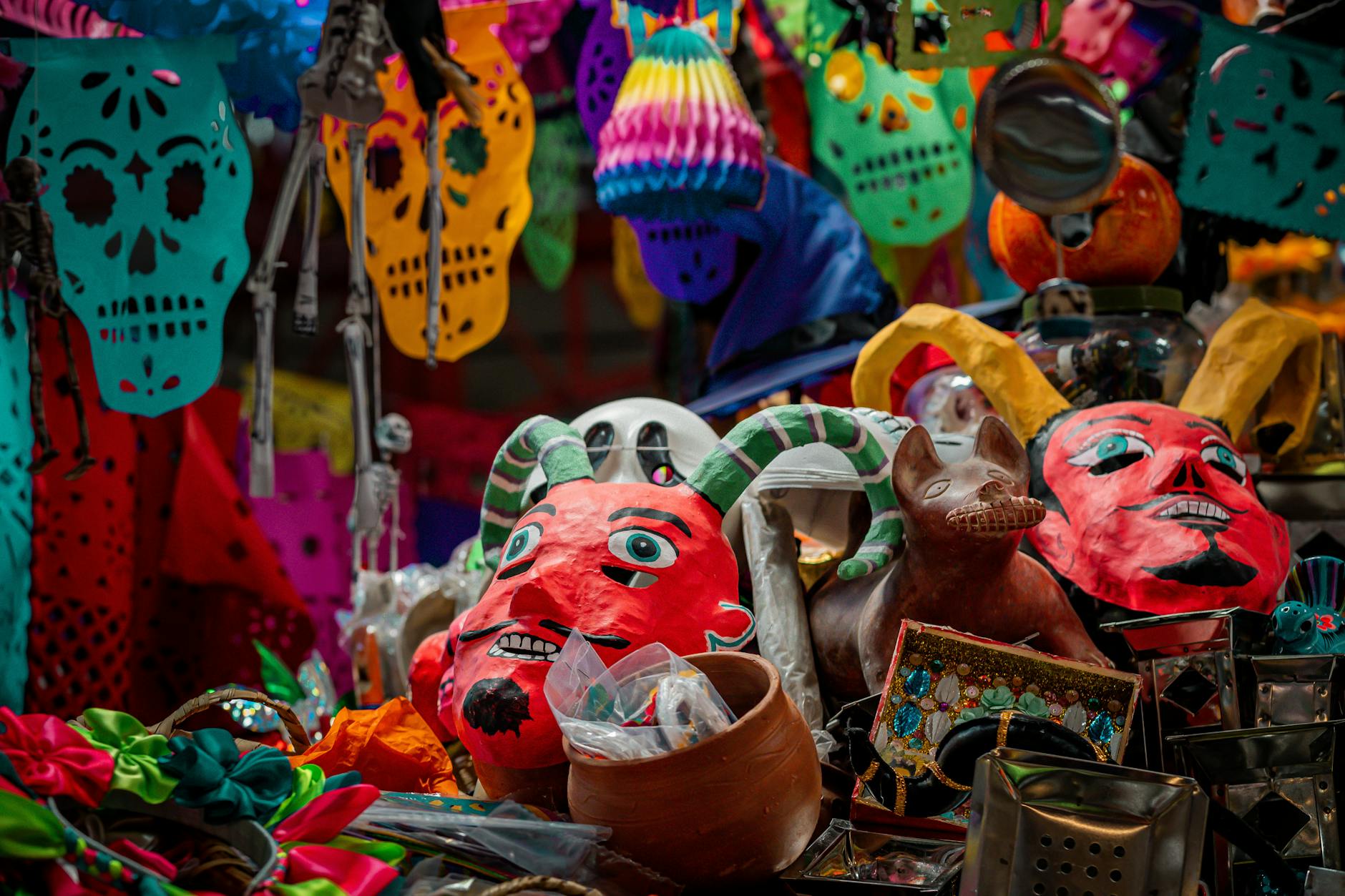 Colorful festival decorations featuring masks and papel picado in Guanajuato, celebrating Mexican culture.