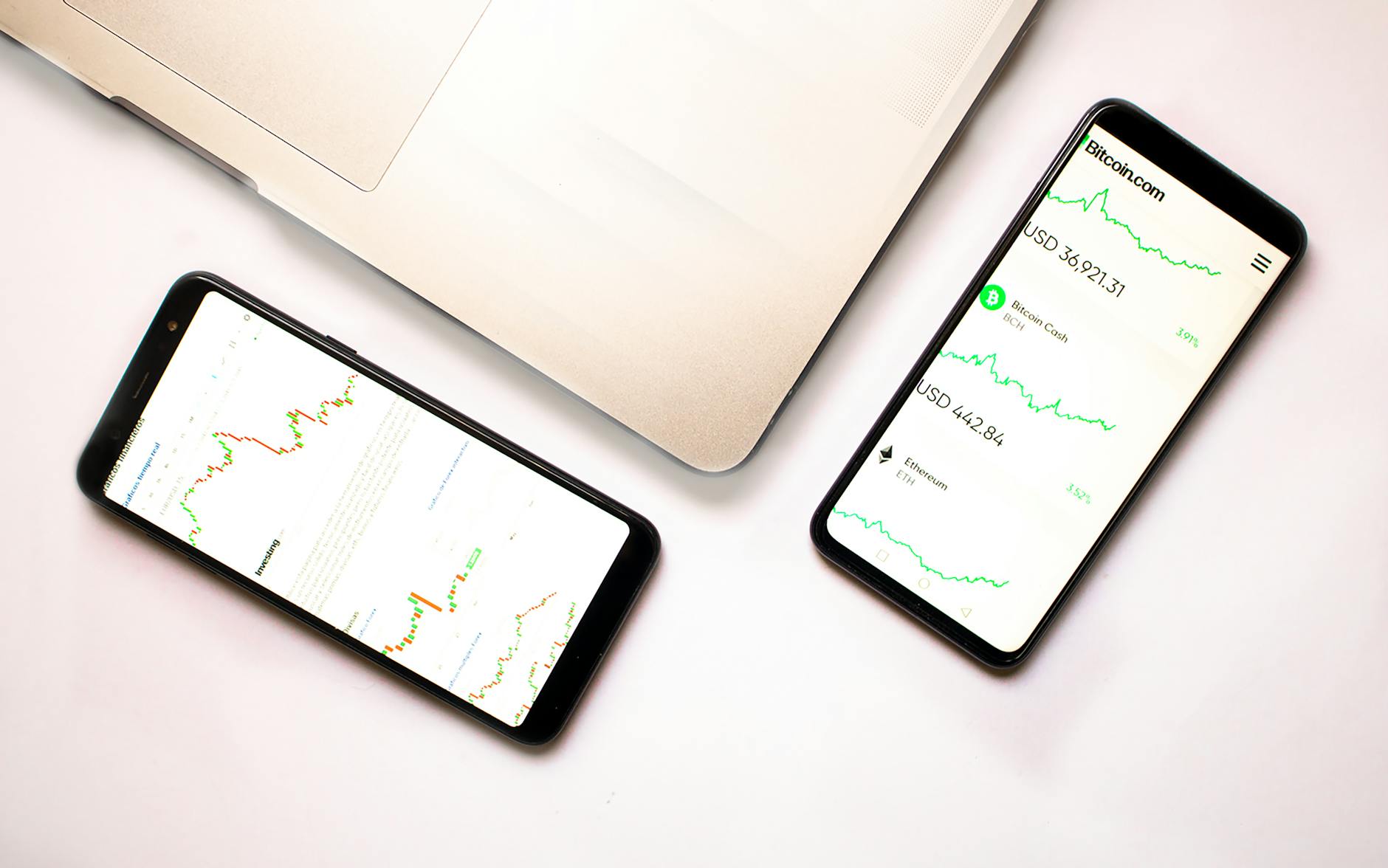 Two smartphones with cryptocurrency data and graphs, ideal for financial insights.