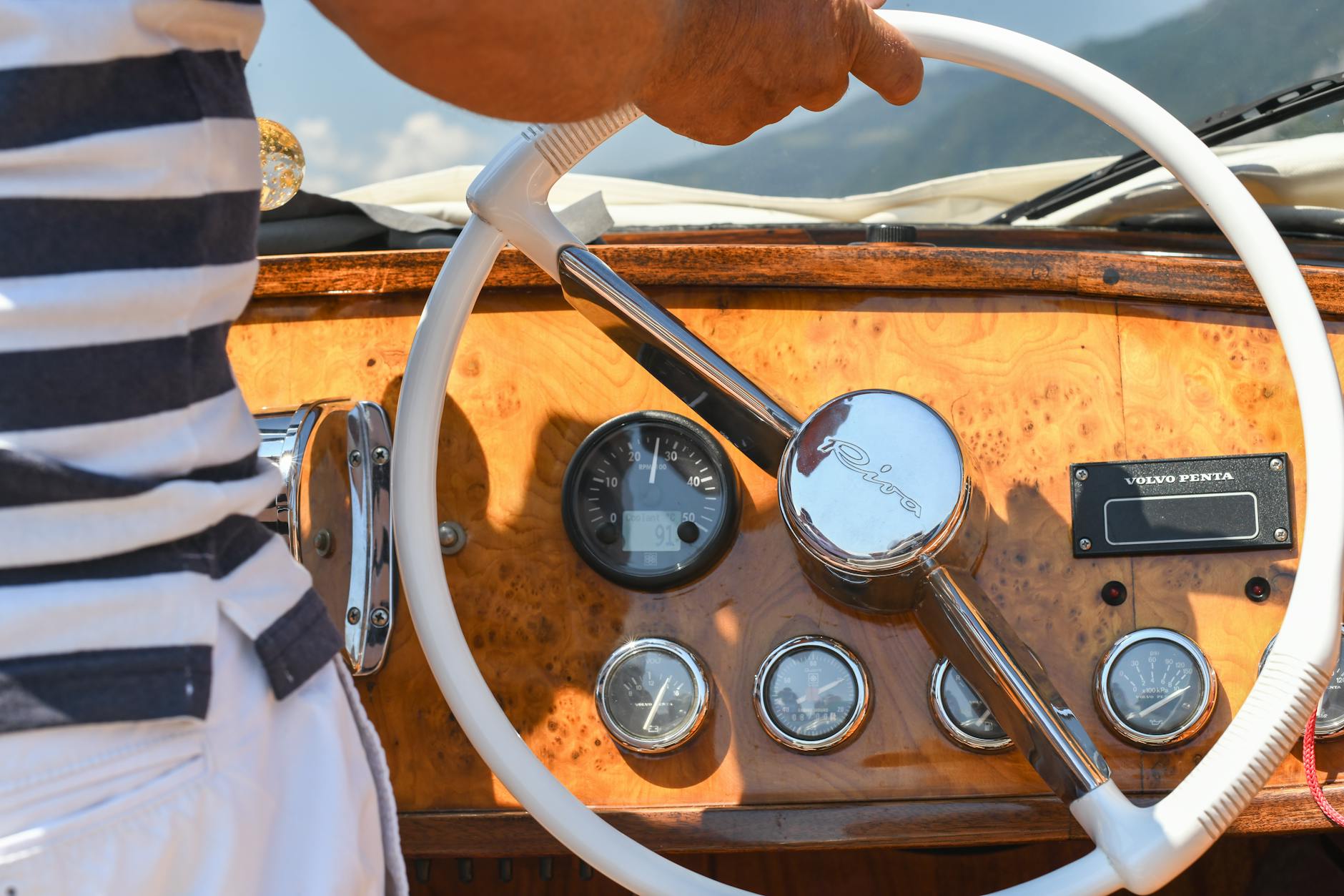 Vintage steering wheel on a motorboat at Lake Como. Luxurious travel in Italy.